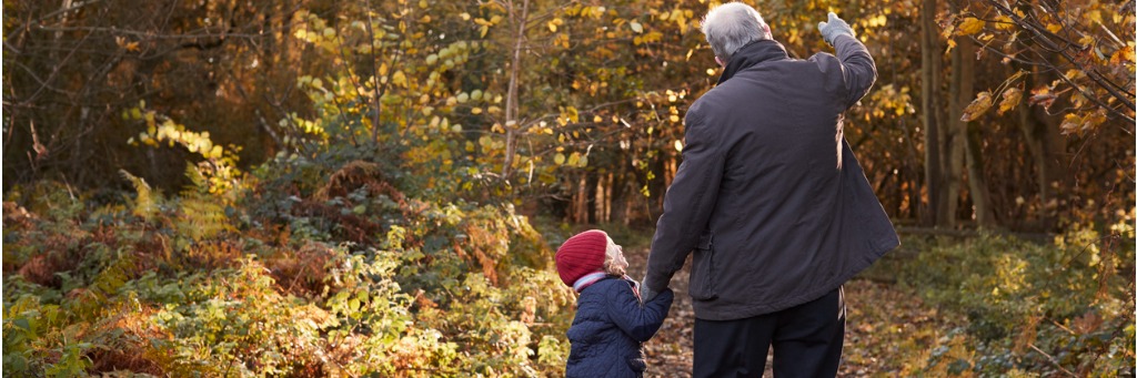 Elderly man and child walking.