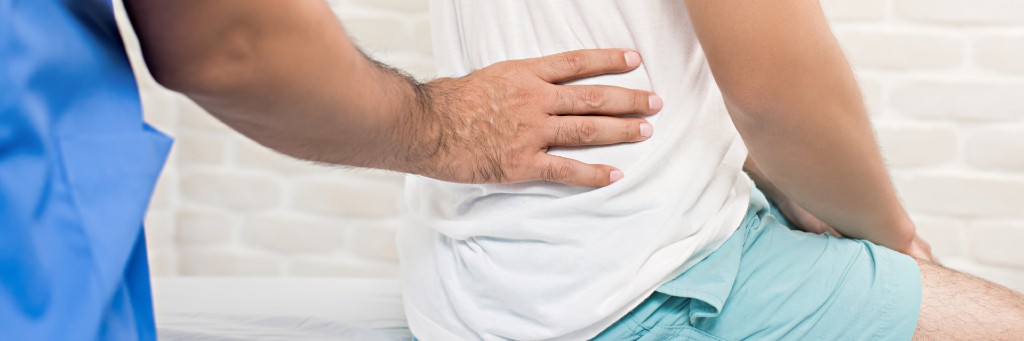 Doctor examining patient's back.