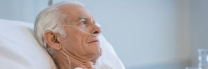 Elderly man resting in hospital.