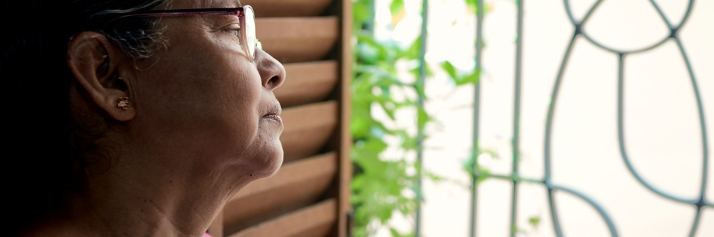 Woman gazing thoughtfully outside.