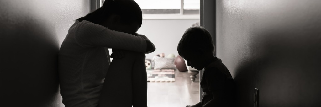 Silhouetted figures sitting in hallway.