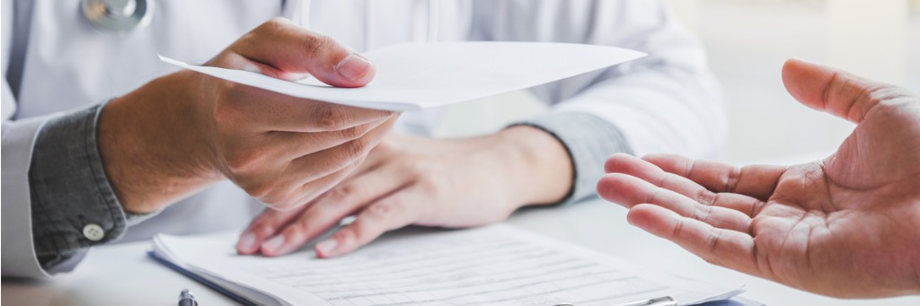 Doctor handing a patient document.